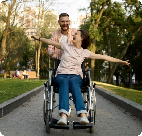 cheerful-love-couple-with-wheelchair-walks-in-park